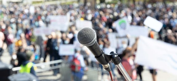 Microphone shot of people at rally